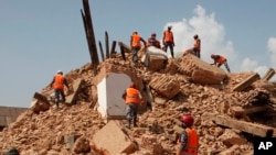 Nepalese soldiers clear the debris at the Kaalmochan temple in Kathmandu, Nepal, Saturday, May 2, 2015. 