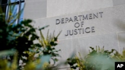 FILE - A sign marks an entrance to the Robert F. Kennedy Department of Justice Building in Washington, Jan. 23, 2023.