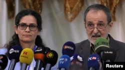FILE - Ilham Ahmed and Riad Darar co-chair's of the Syrian Democratic Council (SDC) are seen during the third meeting in Tabqa, Syria July 16, 2018.