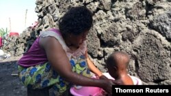 FILE - Ebola survivor Esperance Nyabintu bathes her son Ebenezer Fataki in Goma, eastern Democratic Republic of Congo, Aug. 27, 2020. 