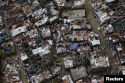 FILE - Damaged houses are seen after Hurricane Matthew passes in Jeremie, Haiti, Oct. 9, 2016.