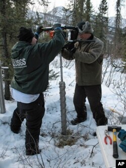 Core samples for microbial analysis are retrieved from the Alaskan permafrost.
