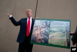 FILE - President Donald Trump talks with reporters as he gets a briefing on border wall prototypes, in San Diego, California March 13, 2018.