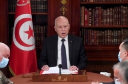 FILE - Tunisia's President Kais Saied presides at a security meeting with members of the army and police forces in Tunis, July 25, 2021.
