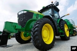FILE - John Deere equipment is on display at the Farm Progress Show in Decatur, Ill., Aug. 31, 2015.