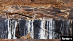 FILE - Uranium ore is heap leached with sulfuric acid at Areva's Somair mine in Arlit on September 25, 2013. 