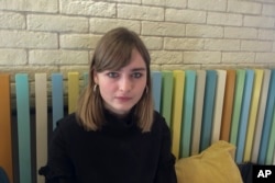 Maria Cheremnova, a 20-year old physics student at Moscow State University who staged a picket to protest the fan zone, poses for a photo in Moscow, Russia, March 24, 2018. Cheremnova is among thousands of students campaigning against the Russia Soccer World Cup disrupting academic life across the country.