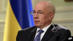FILE - Ukraine's Prime Minister Mykola Azarov speaks during an interview in Kyiv, Ukraine, June 20, 2012. 