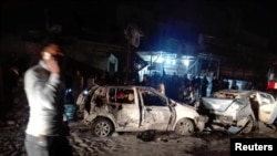 Destroyed cars are seen at the site of a car bomb attack in the Amil neighborhood in Baghdad, Iraq, March 20, 2017. 