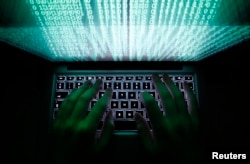 A man types on a computer keyboard in this illustration file picture.