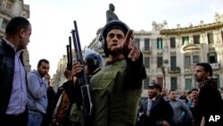 Egyptian security forces disperse people gathering to protest against a court order to release the two sons of ousted Egyptian President Hosni Mubarak in Talaat Harb Square downtown Cairo, Jan. 22, 2015.
