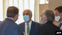 From left, Pakistan's Special Representative for Afghanistan Mohammad Sadiq, US special envoy for Afghanistan Zalmay Khalilzad, and The U.N. Secretary General's personal envoy on Afghanistan Jean Arnault talk at a hotel in Doha, Aug. 10, 2021.