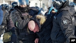 Police detain a man during a protest against the jailing of opposition leader Alexei Navalny in Khabarovsk, 6,100 kilometers east of Moscow, Russia, Jan. 23, 2021.