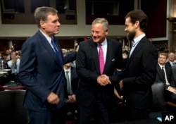 Senate Intelligence Committee Vice Chairman Mark Warner, D-Va., left, and Chairman Richard Burr, R-N.C., center, greet Twitter Chief Executive Officer Jack Dorsey before he testifies before their committee on Capitol Hill, Sept. 5, 2018, in Washington.