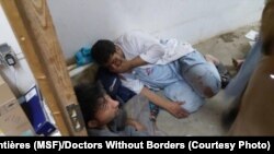 Doctors Without Borders Staff in shock in part of the international medical charity's hospital in Kunduz, Afghanistan, that wasn't destroyed by an apparent airstrike, Oct. 3, 2015.