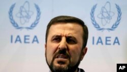 FILE - In this July 10, 2019, file photo,. Iran's Ambassador to the International Atomic Energy Agency, IAEA, Gharib Abadi speaks to the media after the IAEA board of governors meeting at the International Center in Vienna, Austria. 