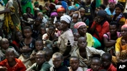 FILE - Refugees who fled Burundi's violence wait to board a U.N. ship, at Kagunga on Lake Tanganyika, Tanzania, to be taken to the port city of Kigoma, May 23, 2015. 