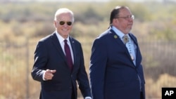 FILE - President Joe Biden and Gila River Indian Community Gov. Stephen Roe Lewis speak at the Gila Crossing Community School, Oct. 25, 2024, in Laveen, Ariz.