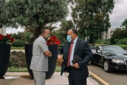 Ethiopian Prime Minister Abiy Ahmed greets an African Union envoy in Addis Ababa, Ethiopia, Nov. 27, 2020, in this picture obtained from social media.