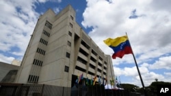 FILE - A Venezuelan flag flies outside the Supreme Court in Caracas, Venezuela, Jan. 22, 2021.