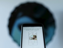 FILE - The dating app Tinder is shown on an Apple iPhone in this photo illustration taken Feb. 10, 2016.