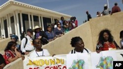 Activists and journalists wait to see former Brazilian President Luiz Inacio Lula da Silva and Senegalese leader Abdoulaye Wade, outside a World Social Forum event attended by the two leaders, at the Place du Souvenir in Dakar, Senegal, February 7, 2011.