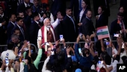 Indian Prime Minister Narendra Modi waves to the crowd after speaking at an event in Uniondale, New York, Sept. 22, 2024.