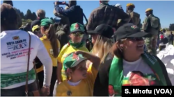 Some of the Zimbabweans following proceedings at the Zanu PF's "white interface rally," July 21, 2018, in Harare where President Emmerson Mnangagwa was addressing the crowd.