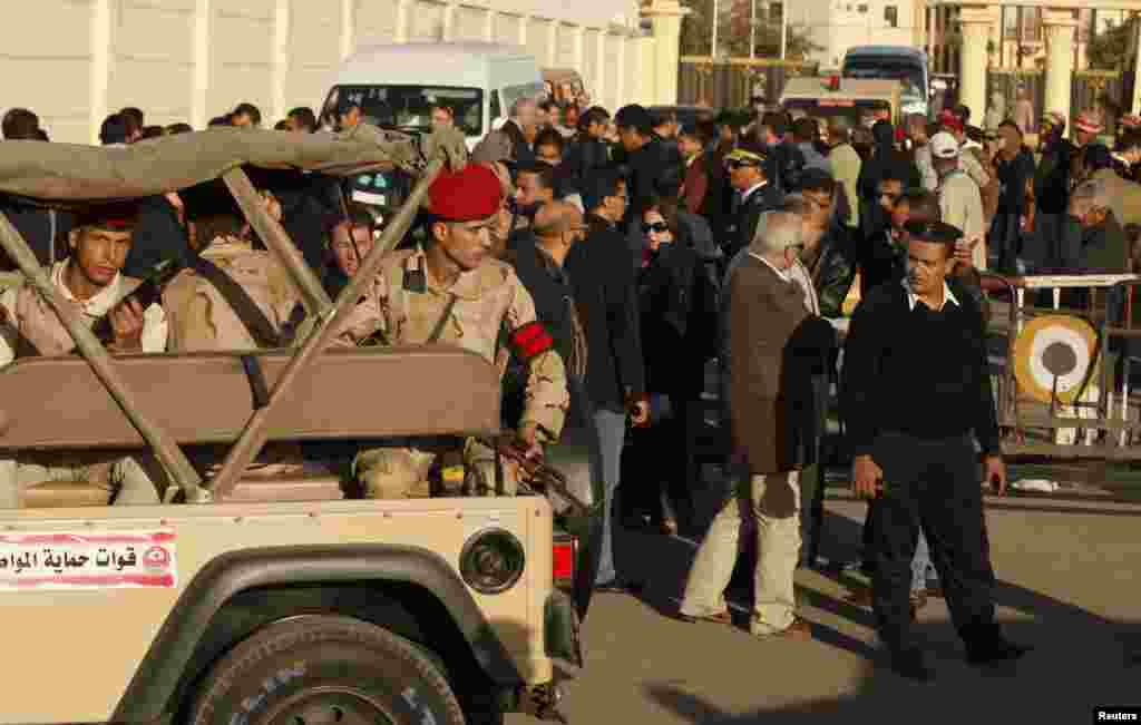 Soldiers provide security near the Almaza military airbase in Cairo during the funerals of army personnel killed in al-Arish.