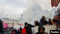Supporters of U.S. President Donald Trump clash with police officers in front of the U.S. Capitol Building in Washington, January 6, 2021.