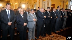 Egyptian President Mohamed Morsi, third left, attends Friday prayers in Cairo, Egypt, April 26, 2013.