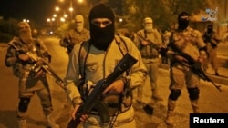 A still image taken from an Islamic State video released through the group's Amaq news agency shows an unidentified militant addressing the camera, reportedly in Mosul, Iraq, on Oct. 18, 2016. 