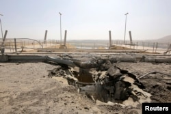 FILE - A crater at the entrance of Mosul Dam. NGOs and humanitarian agencies have already started work on contingency plans in case the dam bursts.