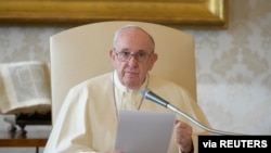 FILE - Pope Francis delivers his weekly general audience from the library in the Apostolic Palace at the Vatican, Nov. 11, 2020. (Vatican Media/Handout)