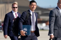 FILE - Acting-Secretary of Homeland Security Chad Wolf, center, arrives to join President Donald Trump at Andrews Air Force Base in Md., Aug. 18, 2020.