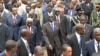 Zimbabwe's President Robert Mugabe (C) and Mozambique's President Armando Guebuza (2nd L red tie) arrive with other regional leaders for a summit of the Southern African Development Community in Mozambique's capital Maputo, August 17, 2012.