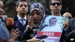 Holding a picture of missing Saudi writer Jamal Khashoggi, Tawakkol Karman, of Yemen the Nobel Peace Prize laureate for 2011, talks to members of the media near the Saudi Arabia consulate in Istanbul, Friday, Oct. 5, 2018. Khashoggi, a 59-year-old veteran journalist who has lived in self-imposed exile in the U.S. since Prince Mohammed's rise to power, disappeared Oct. 2 while on a visit to the consulate to get paperwork done to be married to his Turkish fiancée.