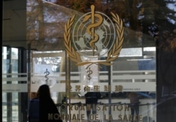 FILE - The World Health Organization's (WHO) logo is seen at the entrance of the UN agency's headquarters in Geneva, Switzerland.