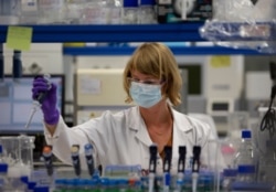 FILE - A lab technician works during research on coronavirus, COVID-19, at Johnson &amp; Johnson subsidiary Janssen Pharmaceutical in Beerse, Belgium, June 17, 2020.
