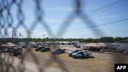 FILE - United States Border Patrol vehicles and temporary structures are pictured under the Del Rio Port of Entry during its reopening after being closed for over a week due to an influx of migrants, Sept. 25, 2021.