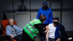 A man receives his first dose of the AstraZeneca COVID-19 vaccine in a mass vaccination site at the Brabanthal event center in Heverlee, Belgium, March 17, 2021.