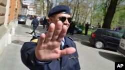 FILE - Bosnian police are seen securing an area around a government building during an investigation, in the capital Sarajevo, April 26, 2013.