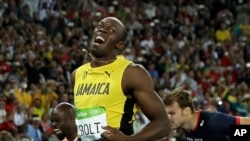 Usain Bolt from Jamaica celebrates after crossing the line to win the gold medal in the men's 200-meter final during the athletics competitions of the 2016 Summer Olympics at the Olympic stadium in Rio de Janeiro, Brazil, Thursday, Aug. 18, 2016.