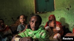 Fatuma Hussein (65, bersama keluarganya duduk di penampungannya di sebuah kamp pengungsi internal akibat pertempuran antara Pasukan Pertahanan Nasional Ethiopia (ENDF) dan pasukan Front Pembebasan Rakyat Tigray (TPLF) di kota Dessie, wilayah Amhara, Ethiopia , 8 Oktober 2021. 