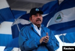 FILE - Nicaraguan President Daniel Ortega applauds during a march in Managua, Sept. 5, 2018.