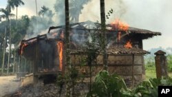 FILE - Houses are on fire in Gawdu Zara village, northern Rakhine state, Myanmar, Sept. 7, 2017.