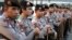 FILE - Indonesian police stand guard ahead of a planned protest at a major intersection in Jakarta, July 22, 2014. 