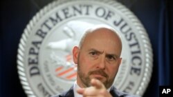 File - U.S. Attorney for District of Massachusetts Andrew Lelling announces indictments in a sweeping college admissions bribery scandal, March 12, 2019, in Boston. 