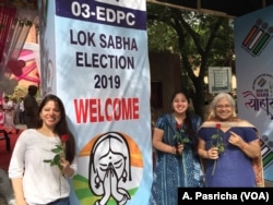Women emerge from a "pink" polling booth set up by the Election Commission in New Delhi on voting day, May 12, 2019, as part of an initiative to marked women's empowerment.