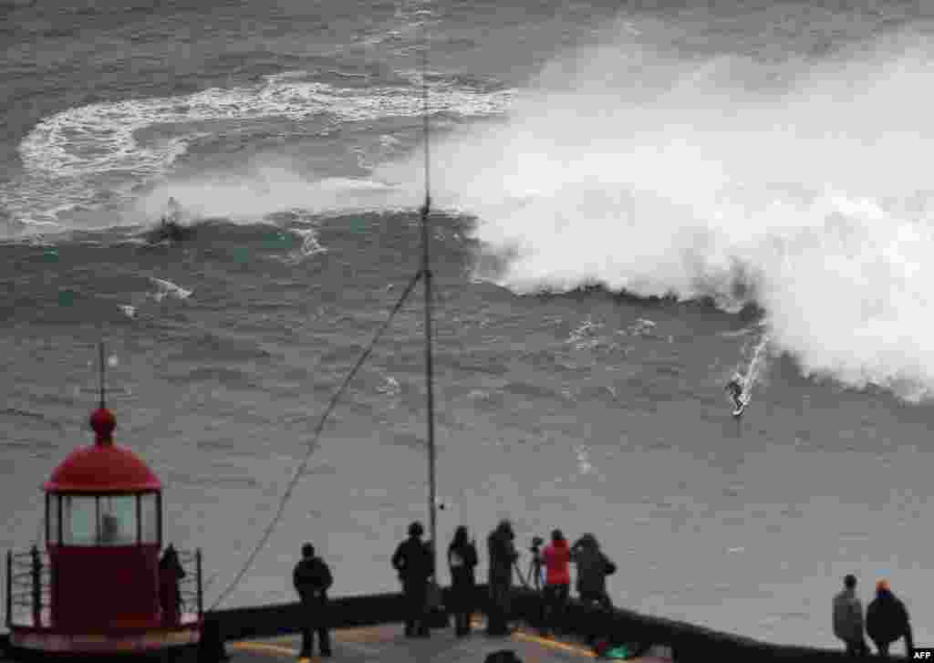 Brazilian big wave surfer Carlos Burle rides a wave in Nazare, central Portugal, Oct. 28, 2013. 